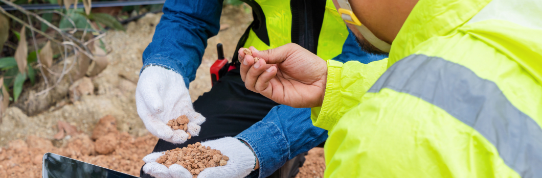 Engineer and foreman analyzing road construction soil before pouring asphalt