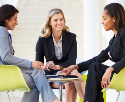 Three businesswomen sitting and meeting