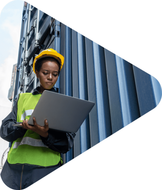 Young African American woman worker at overseas shipping container yard . Logistics supply chain management and international goods export concept .