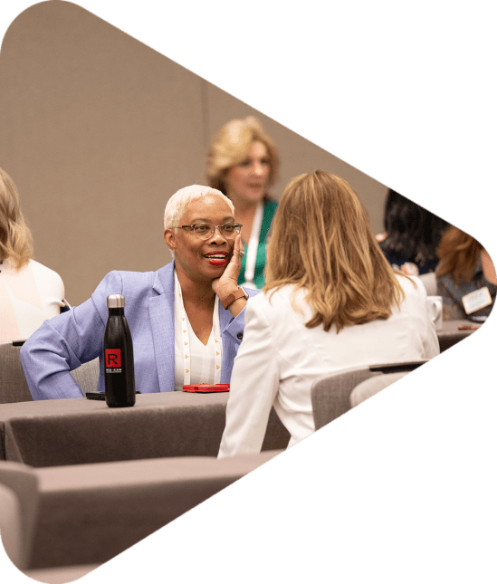 women talking across a table at networking event