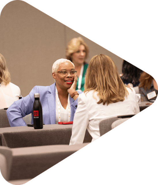 woman talking across tables and crew event