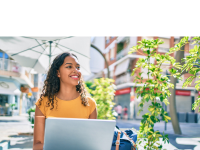 Young african american student girl using laptop sitting on the table at terrace.; Shutterstock ID 1928460668; purchase_order: -; job: -; client: -; other: -