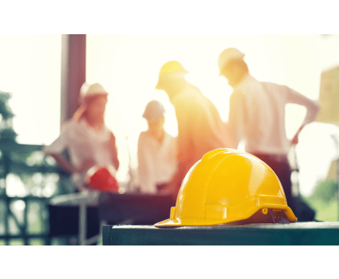 Yellow hard safety helmet hat for safety project of workman as engineer on together joining concept at construction site background.