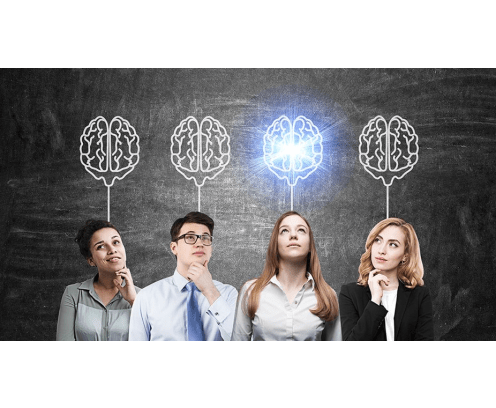 four business people in front of brains drawn on chalkboard