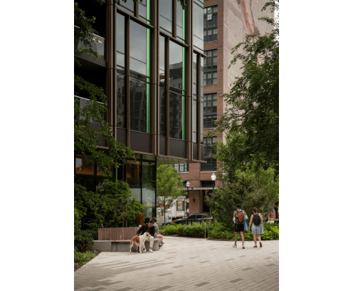 Modern office building with students walkiing toward the door.