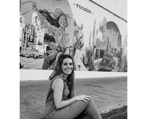 pen-macias-in-front-of-her-large-mural