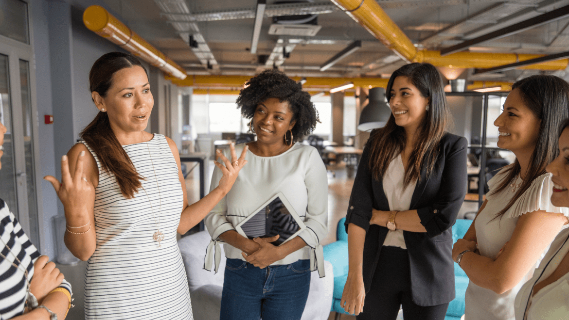 Women gathered together in a modern room in a discussion