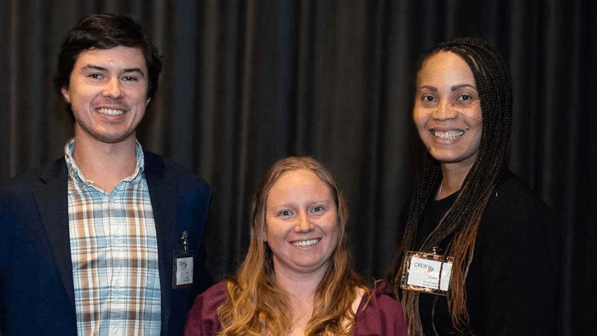 three people smiling at camera