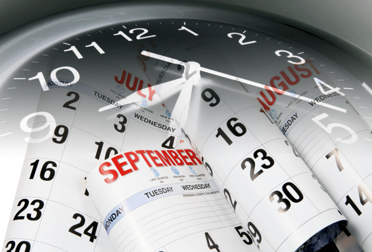 Several calendar months being flipped through inside a clock