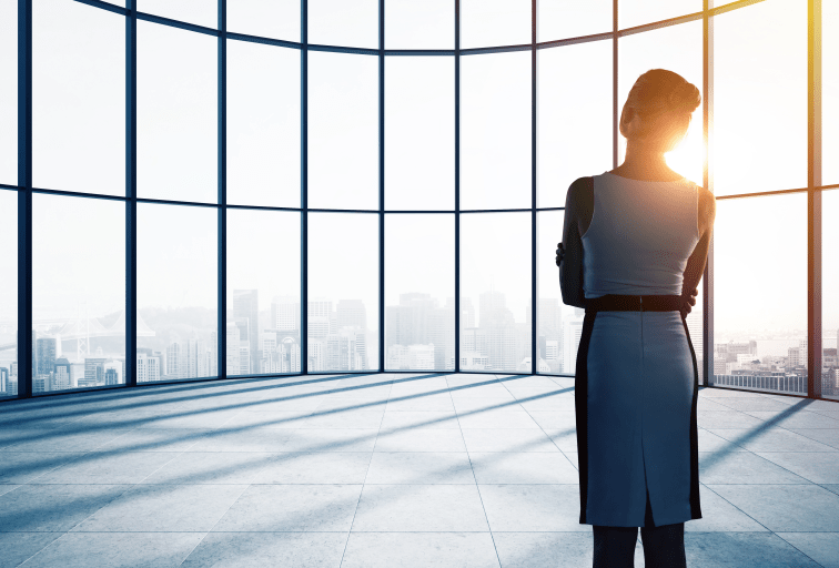 businesswoman thinking in office and looking to window