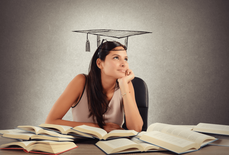 Young student between books dreams the graduation