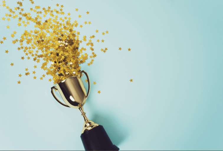 trophy with gold stars pouring out of it