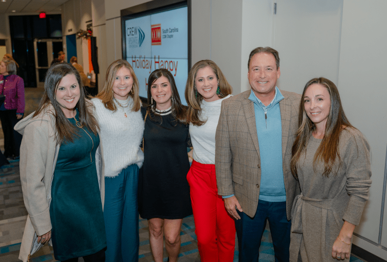 Group of people smiling at a holiday event