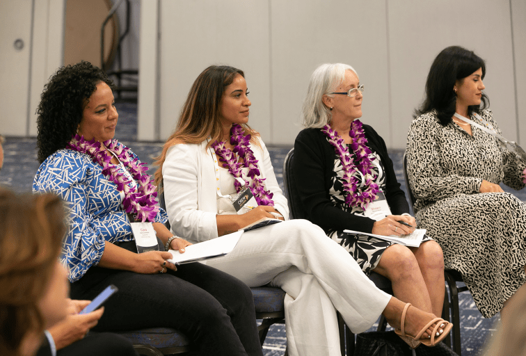 Women sitting watching a presentation