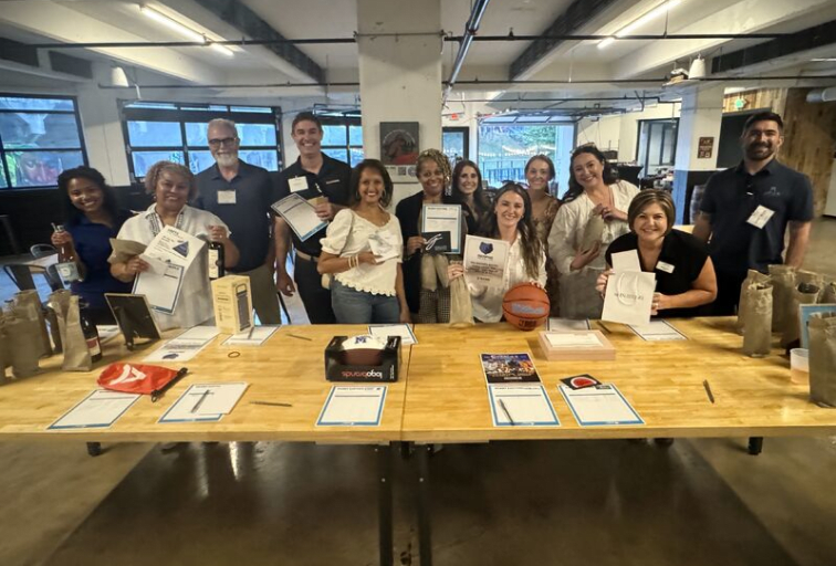 People standing behind a sign up table