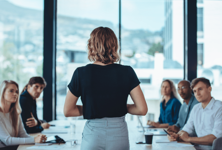 Woman addressing a meeting in office boardroom. Businesswoman having a meeting with her office staff.