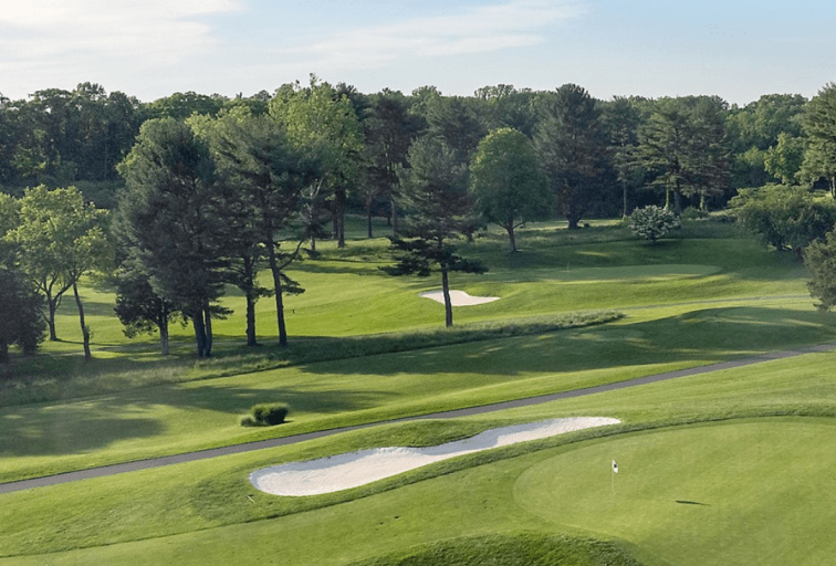 View of golf course, sand traps, trees.