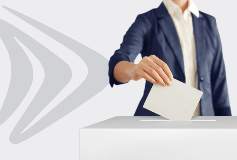 Woman putting a ballot into a voting box.