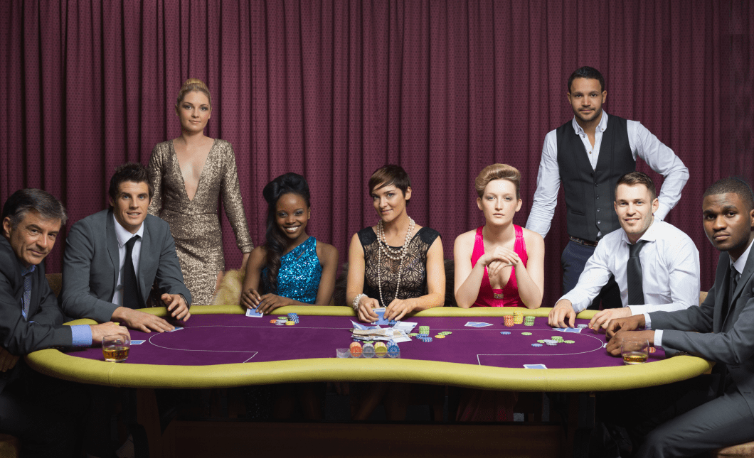 Well-dressed group at poker table in casino