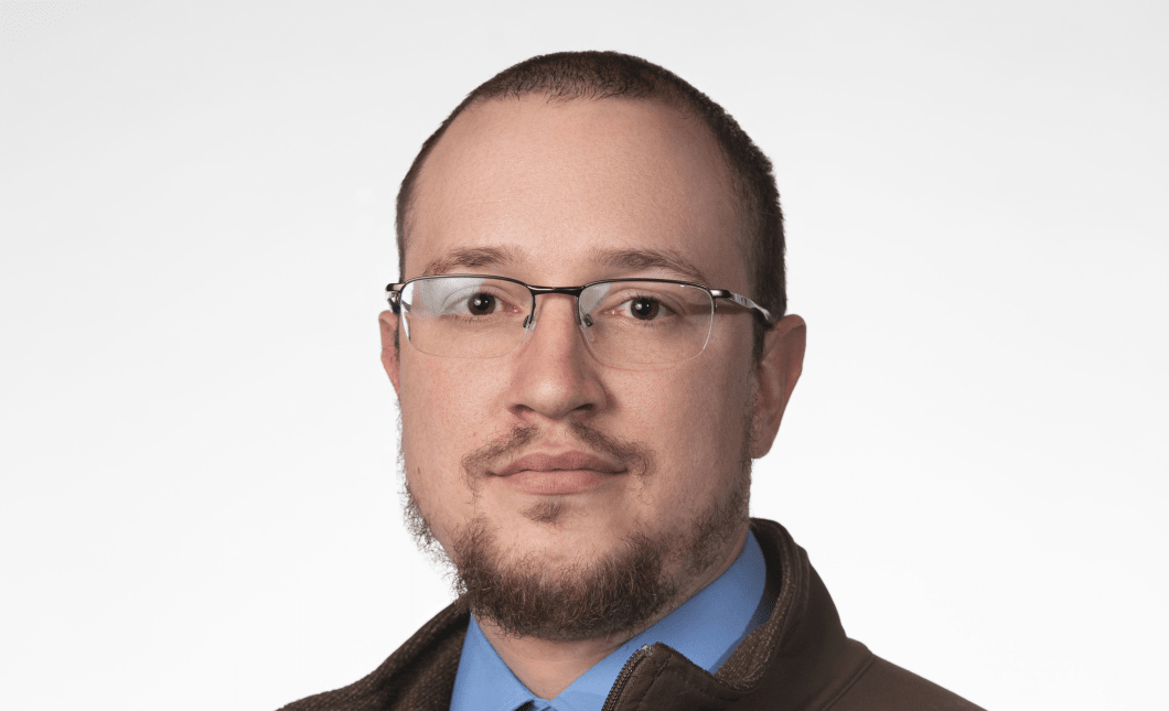 A headshot of Adam Wilhelm.