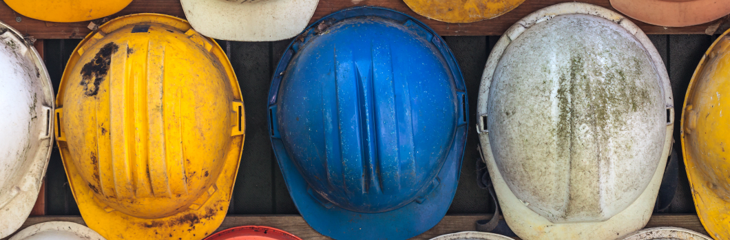Old and worn colorful construction helmets