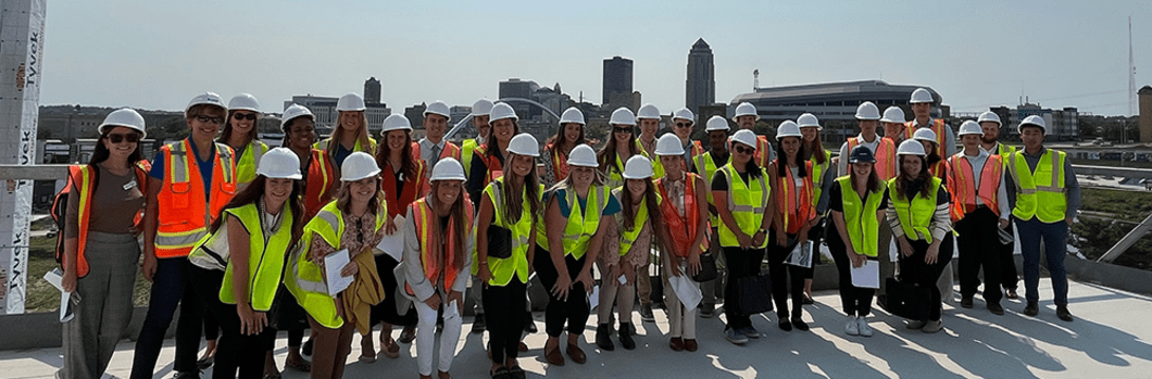 students in high visibility jackets and hard hats on a job site