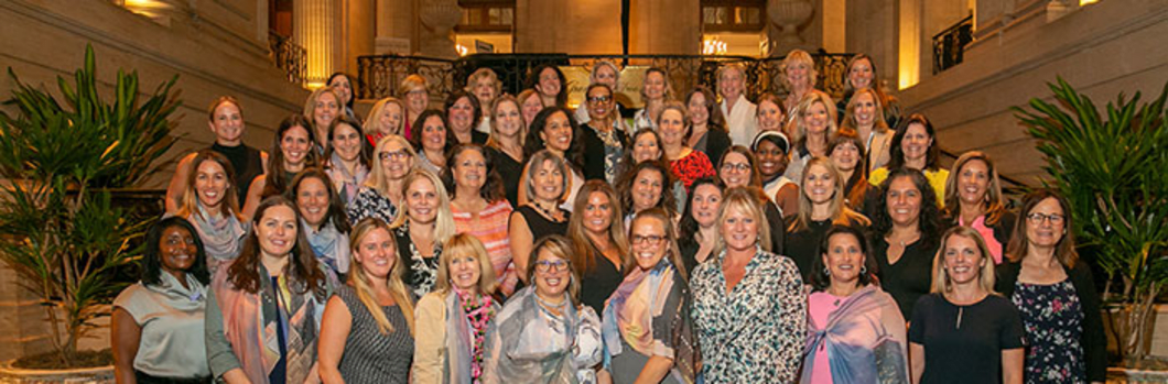 CREW Chicago women posing on a hotel staircase