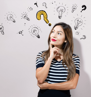 Question with light bulbs with young businesswoman in a thoughtful face