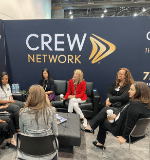 Women connecting at CREW Network ICSC  2022 booth