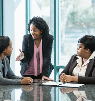 Three women at a table talking