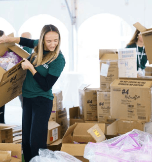 CBRE volunteers moving boxes