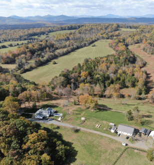 Aerial view of farm - land, house, outbuildings.