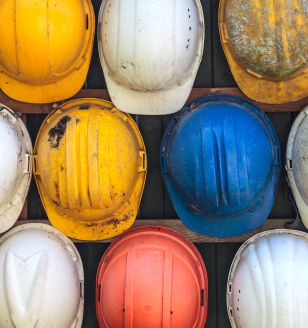 Old and worn colorful construction helmets