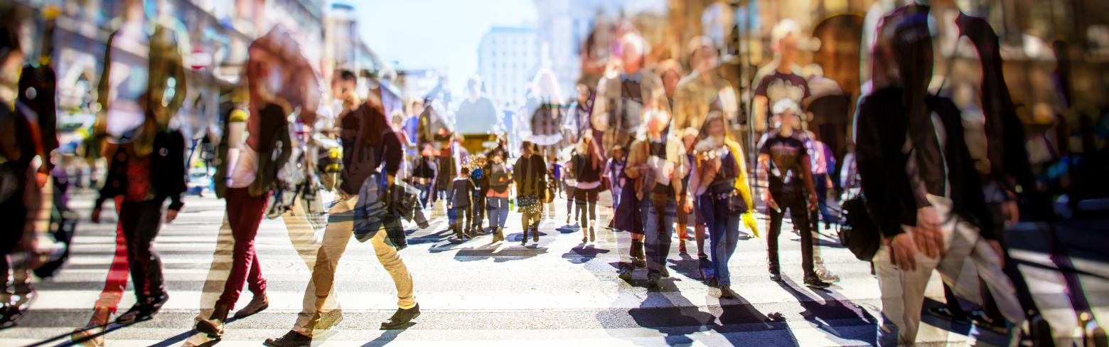 blurred photo of a crowd of people walking on a busy city street