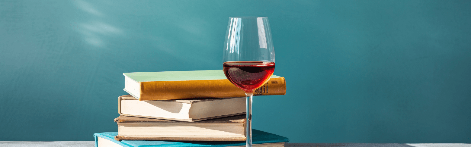 stack-of-book-with-wine-glass-blue-background
