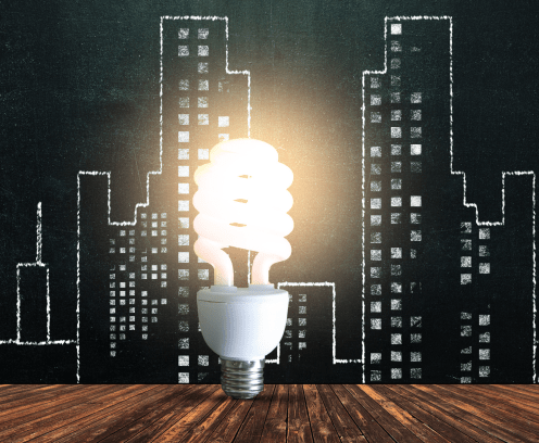 Cityscape chalk drawing with lightbulb