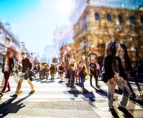 blurred photo of a crowd of people walking on a busy city street