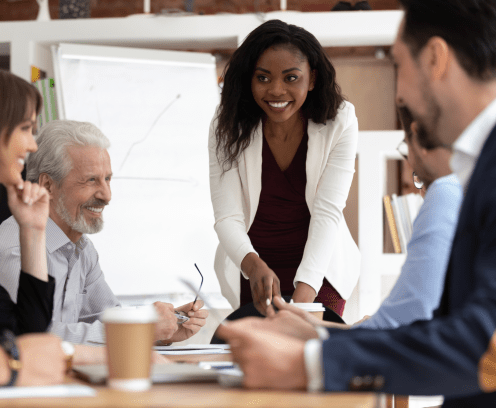 Different ethnicity and age businesspeople gathered together at boardroom for negotiations and planning future collaboration lead by african smiling businesswoman or corporate training process concept