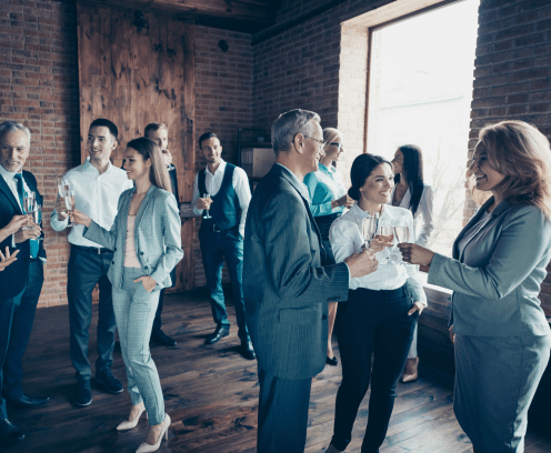 Close up photo business people different age race free leisure excited team building members gathering she her he him his golden beverage toasting best brigade friendship formal wear jackets shirts.