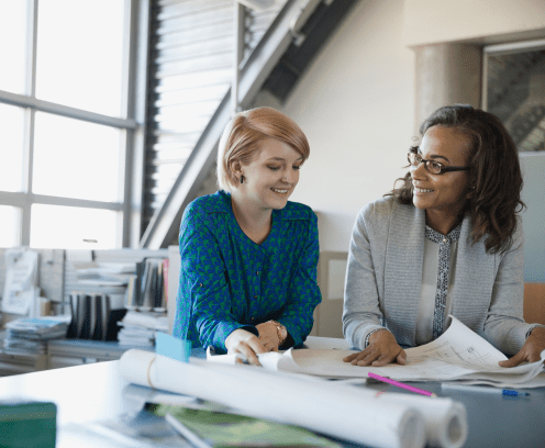 woman mentoring using blueprints