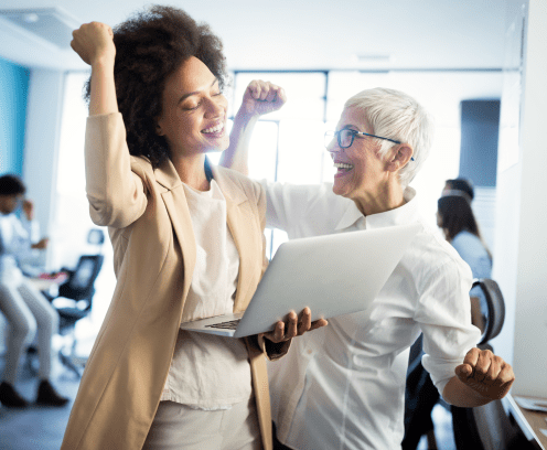 diverse women with arms raised showing success in reaching business goal