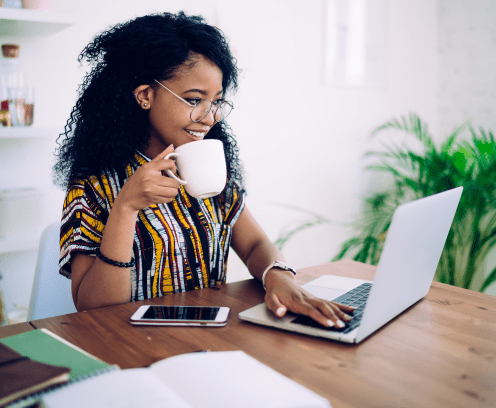 woman-drinking-coffee-working-on-laptop