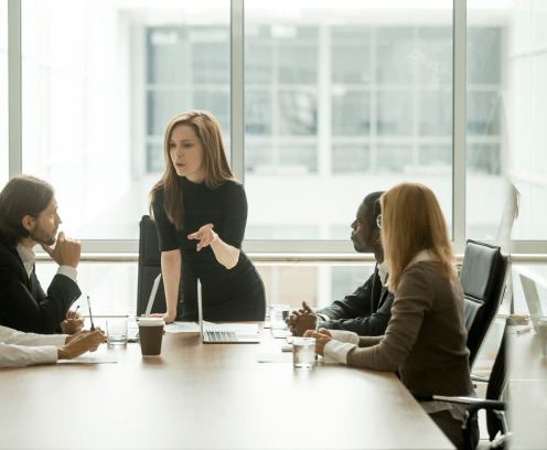 woman leading serious discussion at conference table