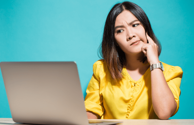 Woman has doubt when she look at laptop