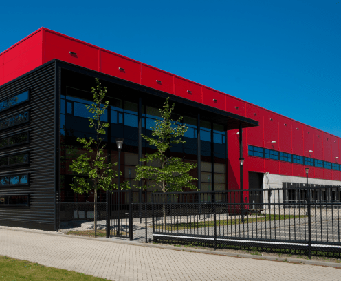 modern red warehouse with office part and loading docks