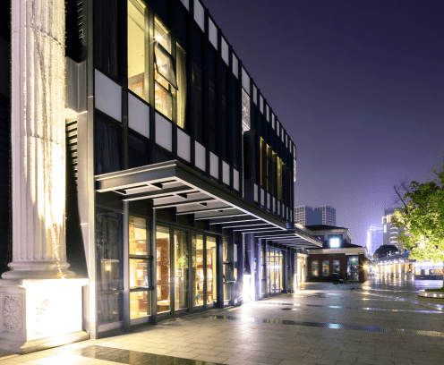 exterior of a vintage shopping mall at night