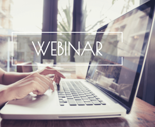 person on a laptop with webinar typed across the front