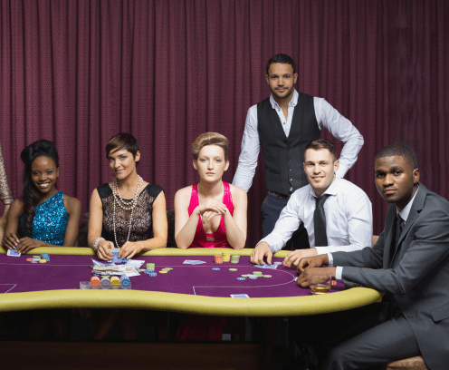Well-dressed group at poker table in casino