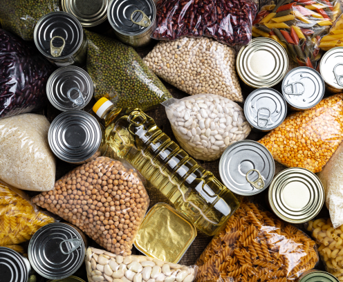 Donations food with canned food on the table background. Donate concept. Close up.