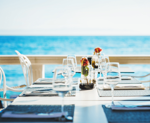 Beach restaurant with sea view in Croatia, table with empty wine glasses